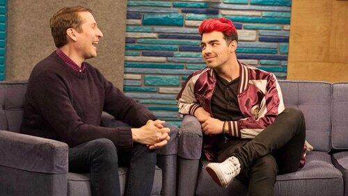 Joe Jonas Wears a Maroon and Gold Letterman Jacket With White Sneakers Joe Jonas Wears a Maroon and Gold Letterman Jacket With White Sneakers
